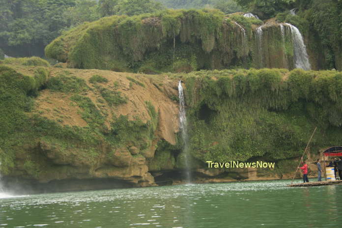 A thick layer of green moss on the surface of the Ban Gioc Waterfall