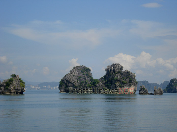 Halong Bay on a clear day with blue sky and bright sunshine