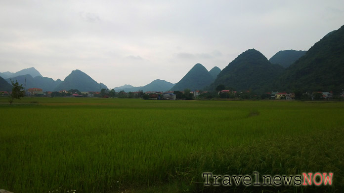 Green rice fields against scenic mountains in the backdrop at the Bac Son Valley in Lang Son Province Vietnam
