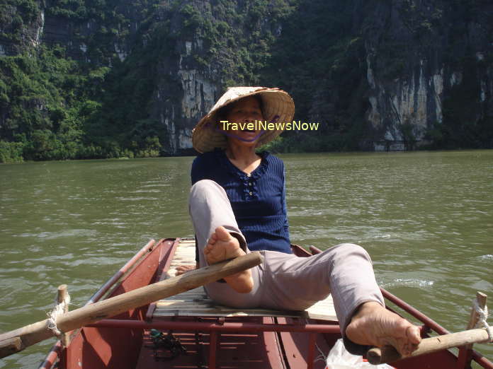 Rowing boat amid the heavenly landscape of Tam Coc